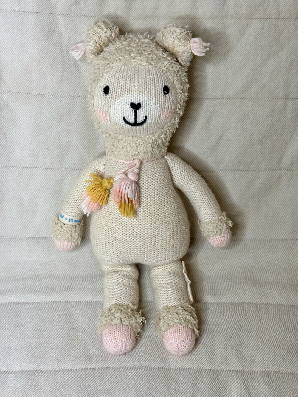Cream Knit Lamb Plush with Pink & Yellow Tassel Accents